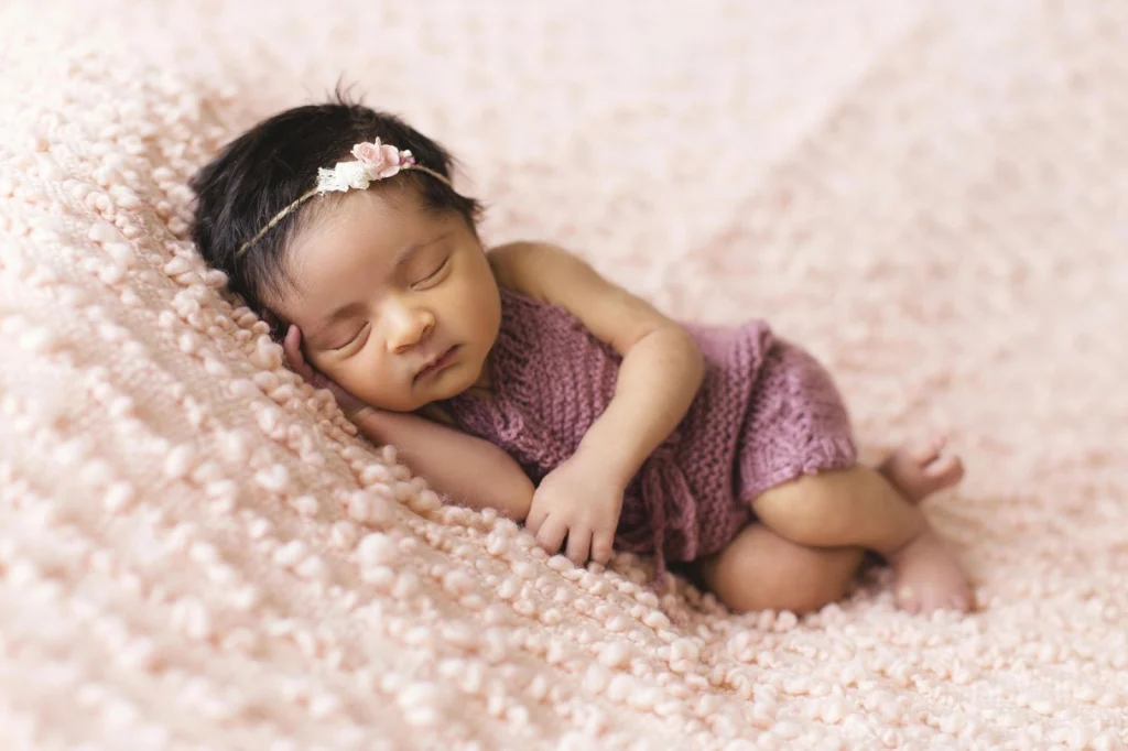 baby sleeping in pink