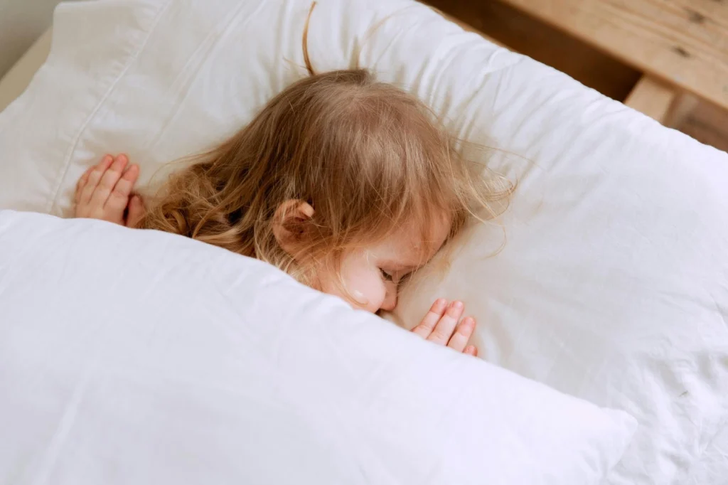 white pillows with baby sleeping